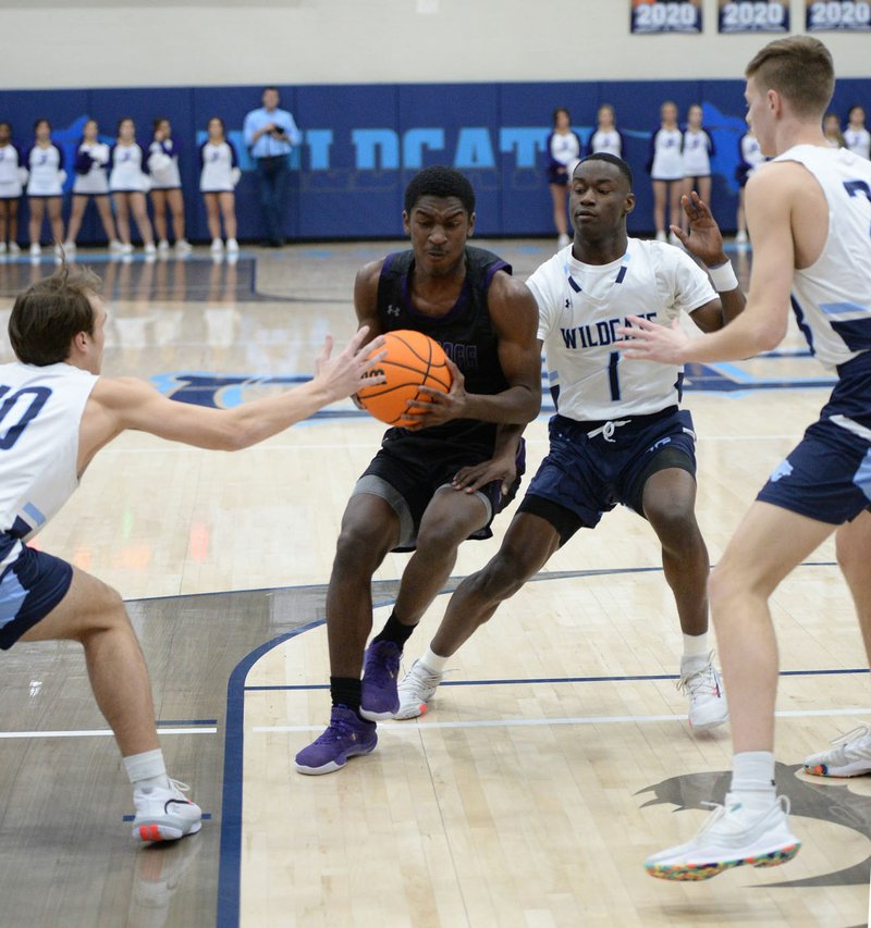 Fayetteville's Isaiah Releford (center) drives to the lane Thursday, Feb. 27, 2020, as he is pressured by Har-Ber's Charlie Bockelman (from left), JaJuan Boyd (1) and Lawson Jenkins during the first half of play in Wildcat Arena in Springdale. Visit nwaonline.com/prepbball/ for a gallery of photographs from the games. (NWA Democrat-Gazette/Andy Shupe)