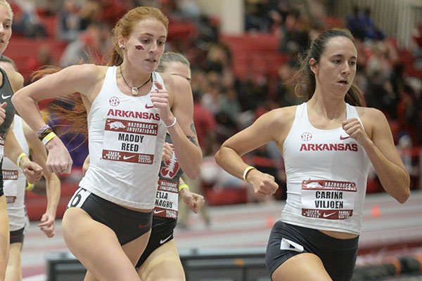 Arkansas' Carina Viljoen (from right) and Maddy Reed lead the field Saturday, Feb. 1, 2020, in the mile run during the Razorback Invitational in the Randal Tyson Track Center in Fayetteville. 