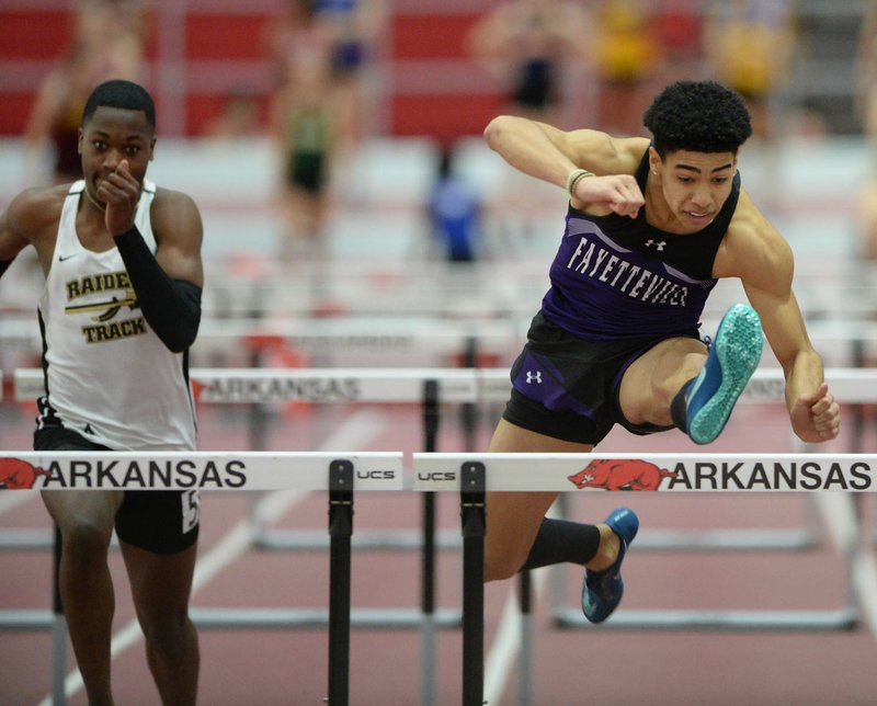 Isaiah Sategna (right) of Fayetteville clears a hurdle Saturday, Feb. 29, 2020, as he leads Will Glass of Nettleton in the 60-meter hurdles during the 5A/6A State Indoor Track and Field Championships in the Randal Tyson Track Center in Fayetteville. Visit nwaonline.com/200301Daily/ for today's photo gallery. (NWA Democrat-Gazette/Andy Shupe)