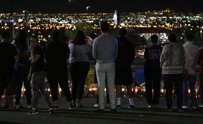 Mourners gather in August at the Walmart in El Paso, Texas, during a vigil for 22 victims of a mass shooting. Proponents of a domestic terrorism law argue that the law would streamline and clarify the patchwork of charges now used against homegrown extremists.
(The New York Times/Jim Wilson)
