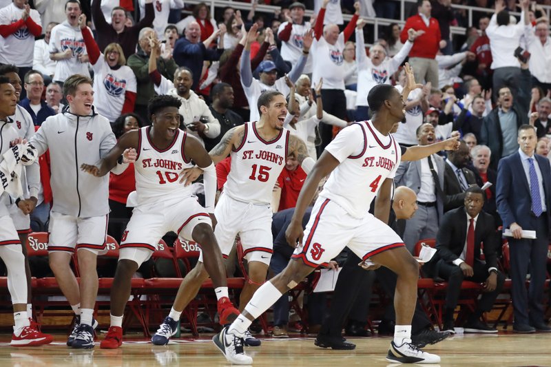St. John's forwards Marcellus Earlington (10) and Damien Sears (15) along with guard Greg Williams Jr. (4) react from the bench during thewaning minutes of the second half of an NCAA college basketball game against Creighton, Sunday, March 1, 2020, in New York. St. Johns upset Creighton 91-71. (AP Photo/Kathy Willens)