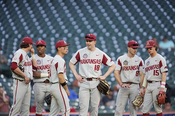 Arkansas teammates (from left to right) Jacob Nesbit, Christian Franklin, Robert Moore, Heston Kjerstad, Braydon Webb and Casey Martin wait for a video review during an NCAA baseball game against Oklahoma on Friday, Feb. 28, 2020, in Houston. (AP Photo/Matt Patterson)