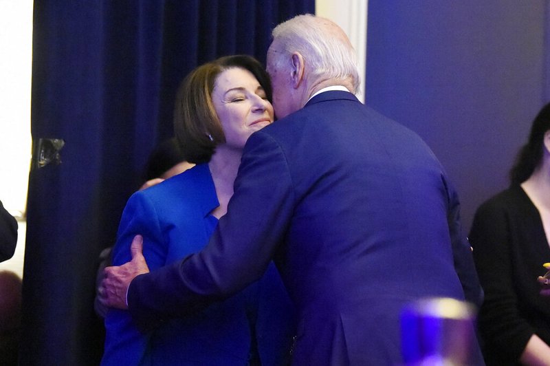 FILE - In this Feb. 24, 2020 photo, file photo Democratic presidential candidates Joe Biden and U.S, Sen. Amy Klobuchar, D-Minn. greet at a South Carolina Democratic Party dinner in Charleston, S.C. Klobuchar ended her Democratic presidential campaign on Monday, March 2, and endorsed rival Biden in an effort to unify moderate voters behind the former vice president's White House bid. (AP Photo/Meg Kinnard, File)