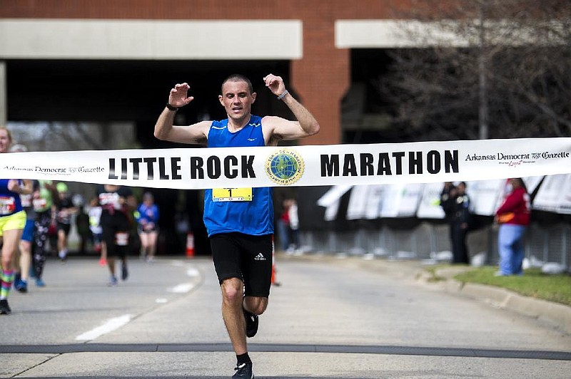 Jeremy Provence crosses the finish line as the male winner of the Little Rock Marathon on Sunday, March 1, 2020. (Arkansas Democrat-Gazette / Stephen Swofford)