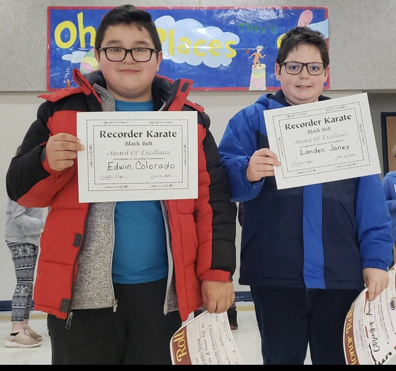 Westside Eagle Observer/SUBMITTED Edwin Colorado (left) and Landon Janes receive their Recorder Karate black belts during Decatur Northside Elementary second quarter honor roll program in the school cafeteria in Decatur Feb. 13.