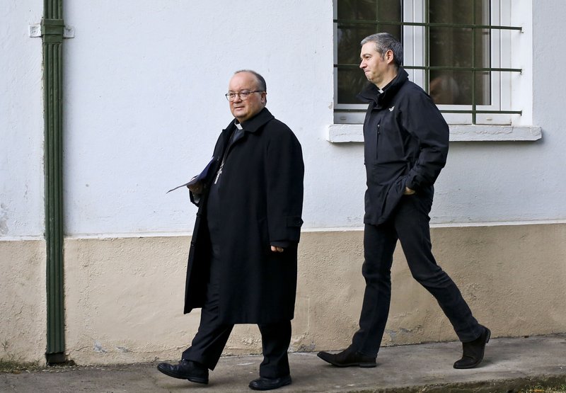 FILE - In this June 19, 2018 file photo, Archbishop Charles Scicluna, left, and Spanish Monsignor Jordi Bertomeu, right, walk in for a press conference, in Santiago, Chile. The Vatican announced Monday, March 2, 2020, that is sending Scicluna and Bertomeu, its top two sex crimes investigators, to Mexico on a fact-finding and assistance mission. (AP Photo/Esteban Felix, File)