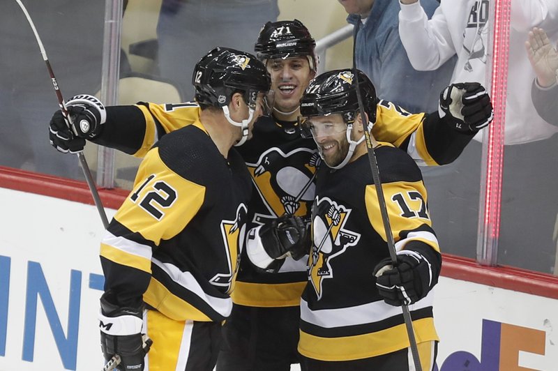 Pittsburgh Penguins' Bryan Rust (17) celebrates with teammates Evgeni Malkin, center, and Patrick Marleau (12) after scoring his third goal of the game against the Ottawa Senators during the third period of Tuesday's game in Pittsburgh. The Penguins won 7-3. - Photo by Keith Srakocic of The Associated Press