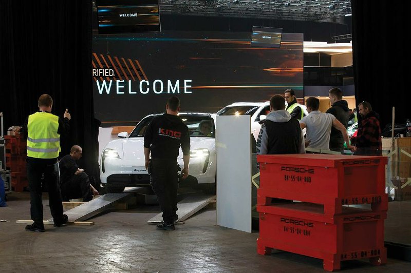 Workers dismantle a booth after the 90th Geneva International Motor Show, which was scheduled to begin Thursday, was canceled by Swiss authorities as a precaution against the spread of the coronavirus.
(AP) story.lead_photo.caption