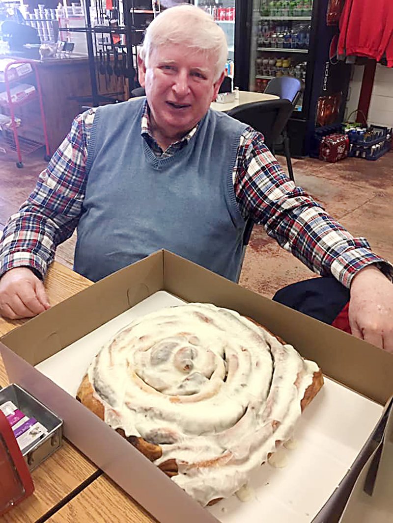 Courtesy photo John White celebrated his 80th birthday in a colossal way with this sweet-sized prize. Sam Baker, co-owner of The Jane Store, created the special larger-than-life cinnamon roll. Baker said White had a big grin on his face when he saw the mammoth cinnamon roll. "He said it was the happiest birthday he ever had," Baker said.