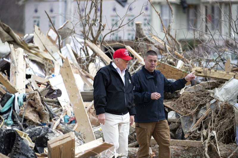 President Donald Trump speaks Mike Herrick, with Putnam County Rescue Squad, as he tours damage from a recent tornado, Friday, March 6, 2020, in Cookeville, Tenn. (AP Photo/Alex Brandon)