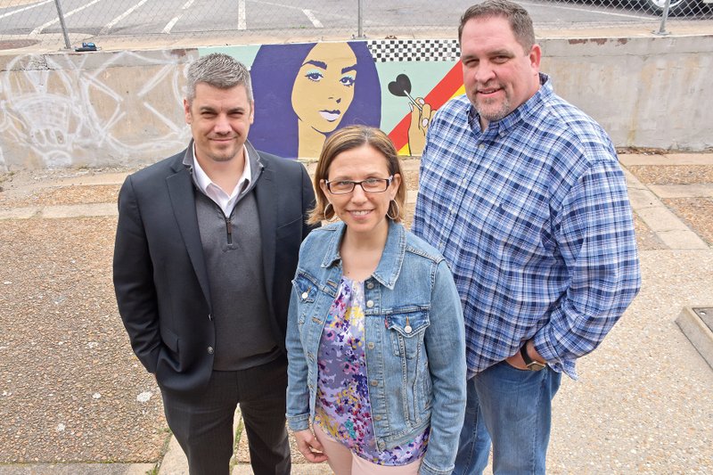 Cabot Mayor Ken Kincade, from left, stands with Cabot Foundation for the Arts and Culture vice president Becky Williams and foundation president John Rudd in front of the paint-a-wall mural behind the Cabot Police Department. The foundation is working with the city to install three murals by the end of the year.