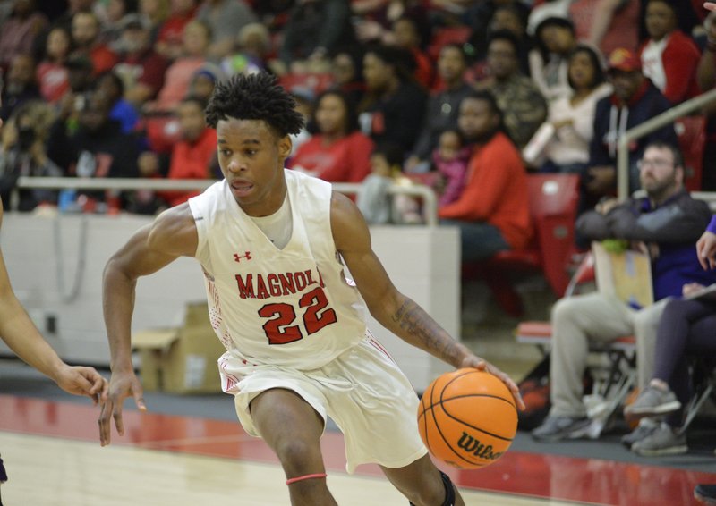  Senior Braelyn Beasley drives to the basket. He tipped in the winning bucket that gave the Panthers their state title last season. (Photo by J.D. Bailey)