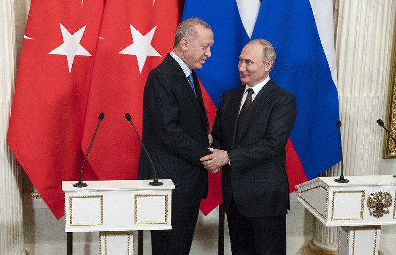 Turkish President President Recep Tayyip Erdogan (left) and Russian President Vladimir Putin hold a news conference Thursday in Moscow after agreeing to a cease-fire in northwest Syria, where dozens of Turkish troops have been killed in clashes with Russia-backed Syrian government troops and more than 1 million civilians have been displaced. Turkey also sent forces to its border with Greece to stop Greek authorities from blocking asylum-seekers from entering from Turkey.
(AP/Pavel Golovkin)