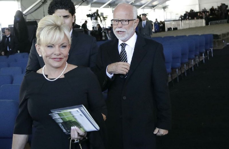 Televangelist Jim Bakker, right, walks with his wife Lori Beth Graham after a funeral service at the Billy Graham Library for the Rev. Billy Graham on Friday, March 2, 2018, in Charlotte, N.C. 
(AP Photo/Chuck Burton)