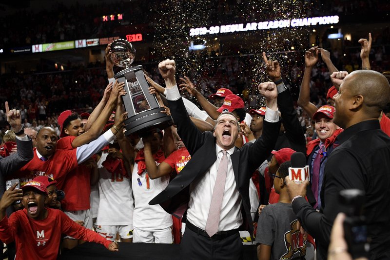 Maryland head coach Mark Turgeon, right center, and his team celebrate after they won a share of the Big Ten regular season title after defeating Michigan in an NCAA college basketball game, Sunday, March 8, 2020, in College Park, Md. (AP Photo/Nick Wass)