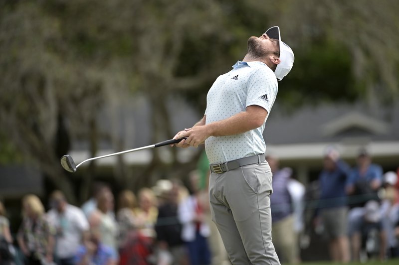 Tyrrell Hatton, of England, stretches before putting on the second green during the final round of the Arnold Palmer Invitational golf tournament, Sunday, March 8, 2020, in Orlando, Fla. (AP Photo/Phelan M. Ebenhack)