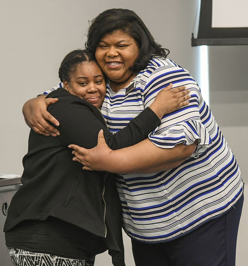 Shaunté Betts, left, a radiology student at National Park College who became the first recipient of the Kristy Carter scholarship, receives a hug from the scholarship's namesake. - Photo by Grace Brown of The Sentinel-Record