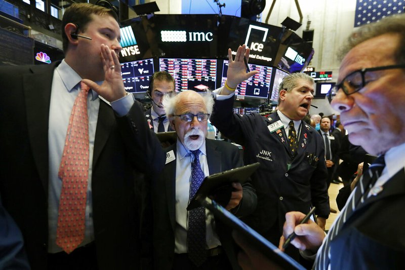 New York Stock Exchange Floor Governor Brendan Connolly, left, works with traders Peter Tuchman, John Panin and Sal Suarino, second left to right, on the floor of the NYSE, Monday, March 9, 2020.
