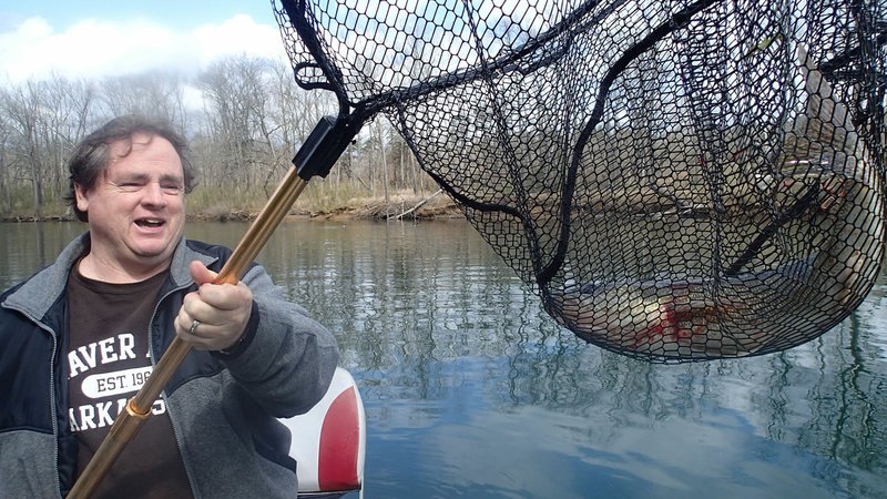 Alan Bland of Rogers shows a walleye that bit a crank bait March 2 2020 at the White River below Beaver Dam. Trolling crank baits is an excellent tactic for catching walleye as they migrate up the tributaries of reservoirs to spawn. Nightcrawlers and minnows are good live baits. (NWA Democrat-Gazette/Flip Putthoff)