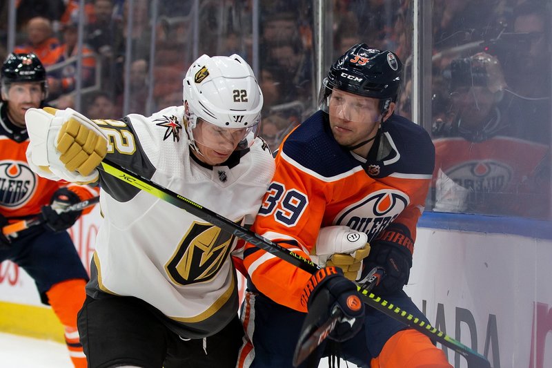 Edmonton Oilers' Alex Chiasson (39) jostles with Vegas Golden Knights' Nick Holden (22) during the second period of Monday'sgame in Edmonton, Alberta. - Photo by Codie McLachlan/The Canadian Press via The Associated Press