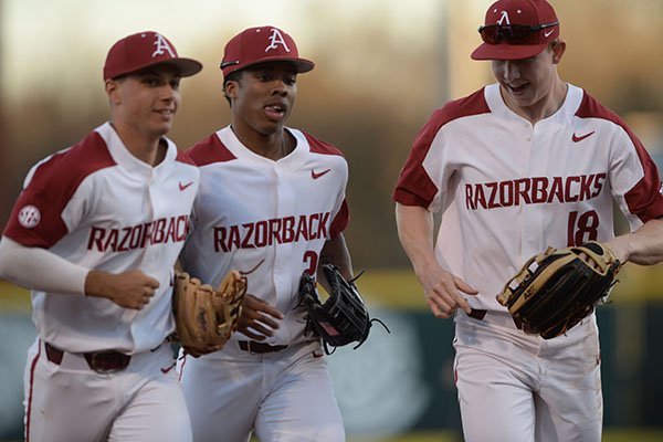 Arkansas center fielder Christian Franklin (center) is congratulated Tuesday, March 10, 2020, by right fielder Heston Kjerstad (right) and second baseman Robert Moore after Franklin threw out Grand Canyon designated hitter Dominic Grissom as Grissom attempted to advance from second to third on a ball hit to the outfield during the second inning at Baum-Walker Stadium in Fayetteville.