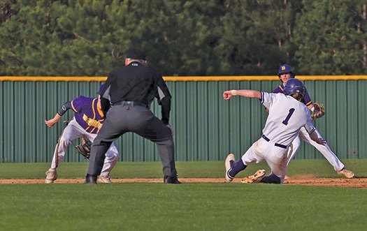 Siandhara Bonnet/News-Times El Dorado's Chase Webb slides into second base as Junction City's Kelly Graves (left) tries to make the tag during their game at the El Dorado-Union County Recreation Complex Tuesday. The Wildcats outlasted the Dragons 5-4 in nine innings. El Dorado hosts Camden Fairview on Thursday, while Junction City plays at Crossett.