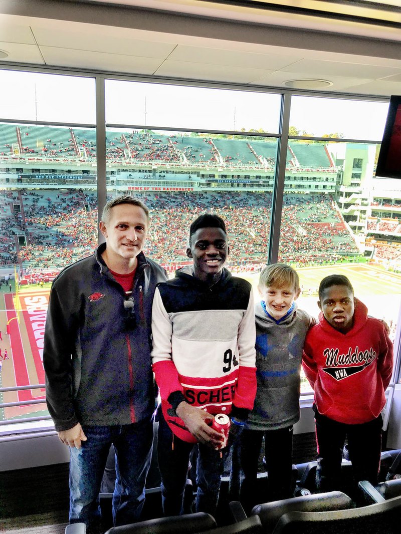 Jacob Hudson (far left) and his son have become good friends with a Canopy family who was resettled in Northwest Arkansas from the Democratic Republic of Congo. (Courtesy Photo)