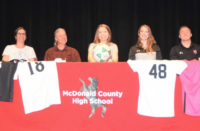 RICK PECK/SPECIAL TO MCDONALD COUNTY PRESS Ava Smith (center), a senior defender on the McDonald County High School soccer team recently signed a letter of intent with NEO A&amp;M Junior College in Miami, Okla. From left to right (Kristi Smith (Mom), Jamey Smith (Dad), Ava Smith, Emily Sumler (MCHS assistant coach) and John DelaTorre (MCHS coach).