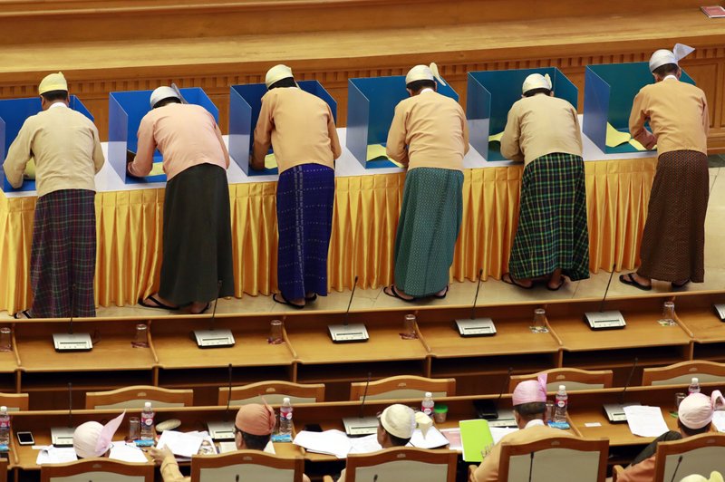 Parliament members cast their votes to amend the 2008 Constitution at Union parliament Wednesday, March. 11, 2020, in Naypyitaw, Myanmar. (AP Photo/Aung Shine Oo)