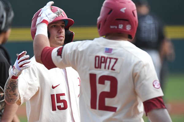 Arkansas shortstop Casey Martin (15) is greeted at home plate by catcher Casey Opitz (12) after Martin hit a home run during a game against Grand Canyon on Wednesday, March 11, 2020, in Fayetteville. 