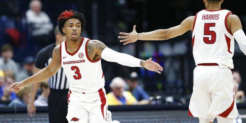 Arkansas guard Desi Sills (3) is congratulated by Jalen Harris (5) after Sills scored against Vanderbilt in the first half of an NCAA college basketball game in the Southeastern Conference Tournament Wednesday, March 11, 2020, in Nashville, Tenn. (AP Photo/Mark Humphrey)