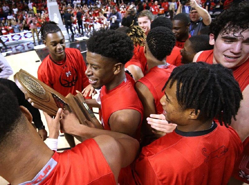 Magnolia players celebrate the Panthers' 78-76 win over Mills in the 2019 Class 4A boys basketball state championship on Saturday, March 9, 2019, at Bank OZK Arena in Hot Springs.
