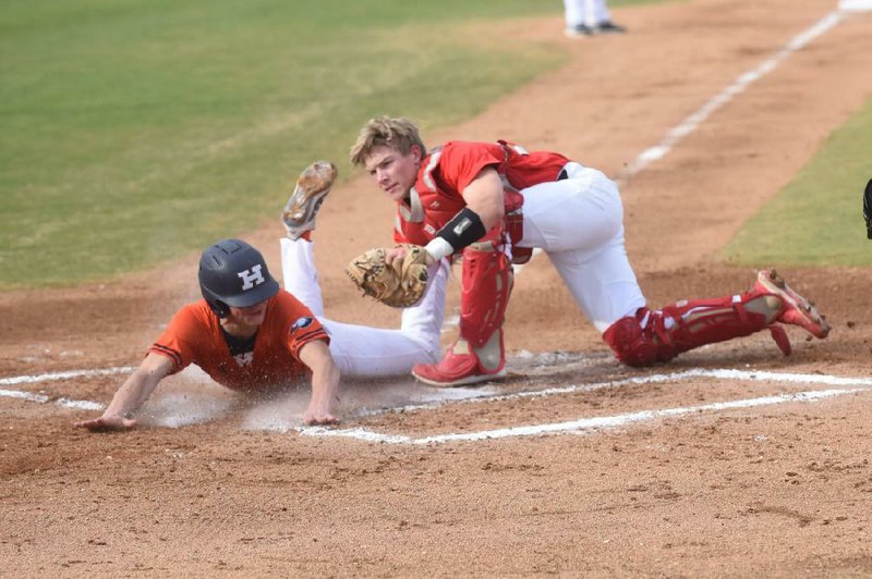 Farmington catcher Trey Hill (right) tags out Rogers Heritage’s Jeb Brown at the plate Wednesday in the War Eagles’ 10-7 victory at Rogers. Go to nwaonline.com/200312Daily/ to see more photos.
(NWA Democrat-Gazette/Flip Putthoff)