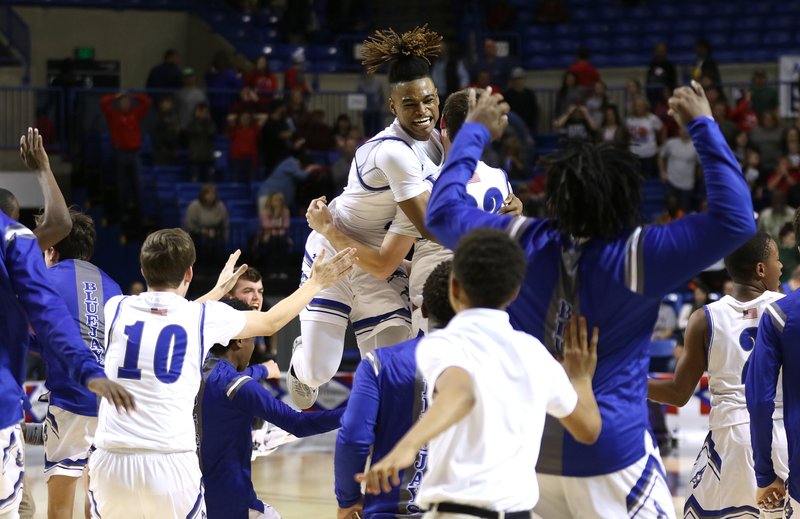 Nevada's Javontae Pearson (top center) celebrates with teammates after the Blue Jays' 48-47 win over Izard County in the Class 1A boys basketball state championship game on Thursday at Bank OZK Arena. - Photo by Thomas Metthe of Arkansas Democrat-Gazette
