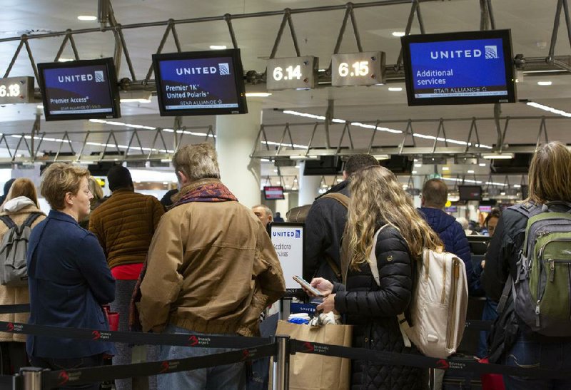 People wait to check in for a flight to Chicago on Thursday at Brussels International Airport. Airlines scrambled to cancel flights and reassure anxious travelers after President Donald Trump announced a 30-day ban on Europeans traveling to the U.S.
(AP/Virginia Mayo)