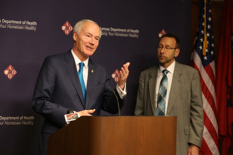 Gov. Asa Hutchinson gives a press conference about new coronavirus cases as Arkansas Secretary of Health, Dr. Nate Smith looks on in this Friday, March 13, 2020, file photo at the Arkansas Department of Health in Little Rock. 
(Arkansas Democrat-Gazette/Thomas Metthe)