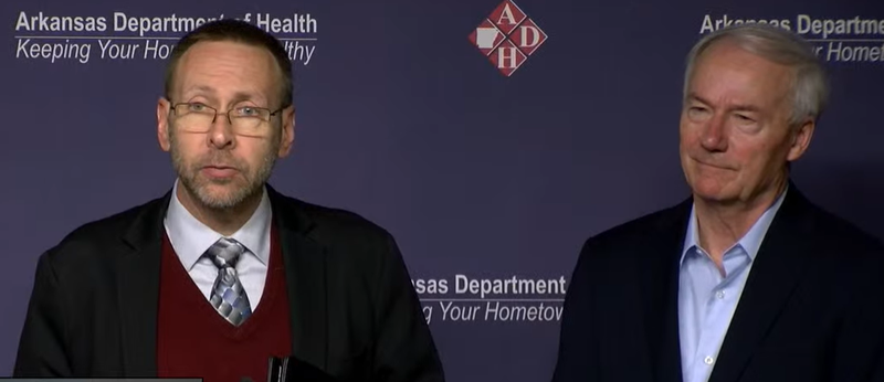 Secretary of Health Dr. Nate Smith, left, speaks at a news conference Saturday alongside Arkansas Gov. Asa Hutchinson in this screenshot from a live feed.