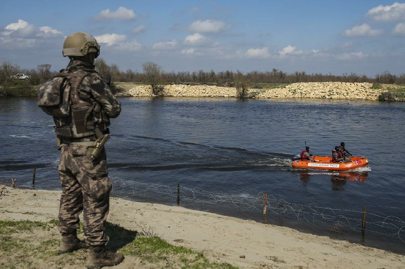 Turkish special force troops patrol in a speedboat earlier this week along the Maritsa River at the Turkish-Greek border near Karpuzlu village in Turkey.
(AP/Emrah Gurel)