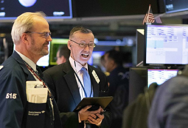 Traders work Friday at the New York Stock Exchange where stocks regained most of their losses from Thursday’s rout. More photos available at arkansasonline.com/314stocks/.
(AP/Mark Lennihan)