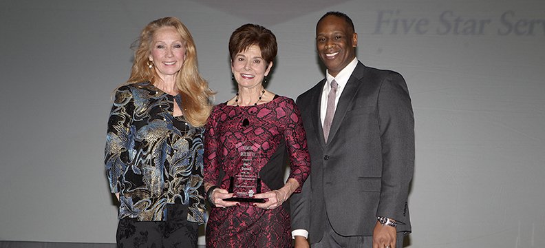 Serethia Crawford, left, and Greater Hot Springs Chamber of Commerce outgoing board president Bryan Smith, right, present Cindy Baswell with the Woman of the Year Award at the Greater Hot Springs Chamber of Commerce annual meeting &amp; awards banquet Thursday, January 22, 2015. -Photo by Richard Rasmussen of The Sentinel-Record