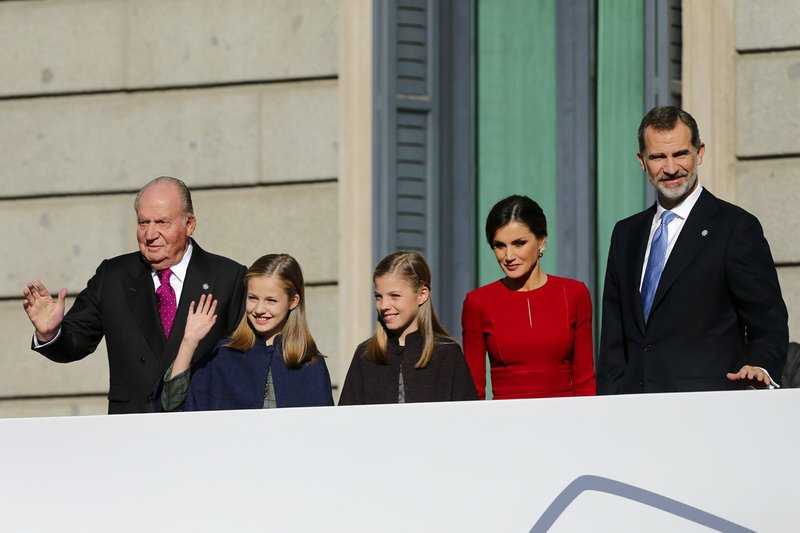 Spain's King Felipe VI (right) and his wife, Queen Letizia, look at the crowd with their daughters Princess Leonor (second left) and Princess Sofia, and the king's father, former King Juan Carlos, after their arrival for celebrations of the 40th anniversary of the Spanish Constitution at the Spanish parliament in Madrid, Spain, in this Dec. 6, 2018, file photo.