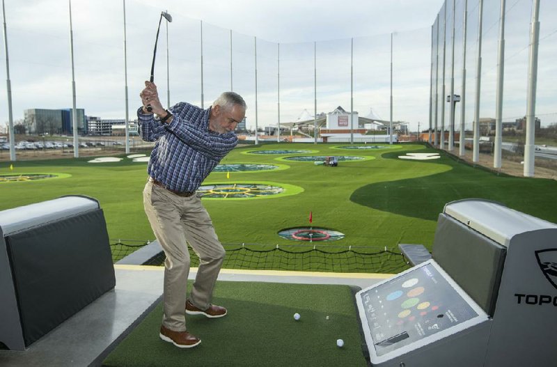 Rich Davis of Northwest Arkansas swings Wednesday during the Taste and Tour preview event at Topgolf Northwest Arkansas in Rogers. Employees of local businesses had the opportunity to sample what the venue has to offer before it opens to the gen- eral public later in March. Go to nwaonline.com/200312Daily/ for today’s photo gallery. 
(NWA Democrat-Gazette/Ben Goff) 
