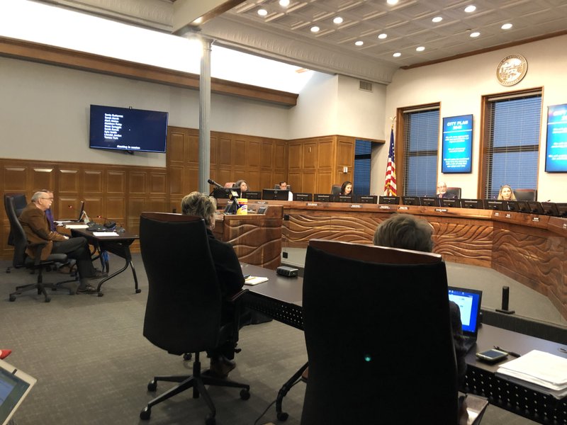 Fayetteville City Council members and Mayor Lioneld Jordan are spread apart during a special meeting of the council Monday. (NWA Democrat-Gazette/STACY RYBURN)