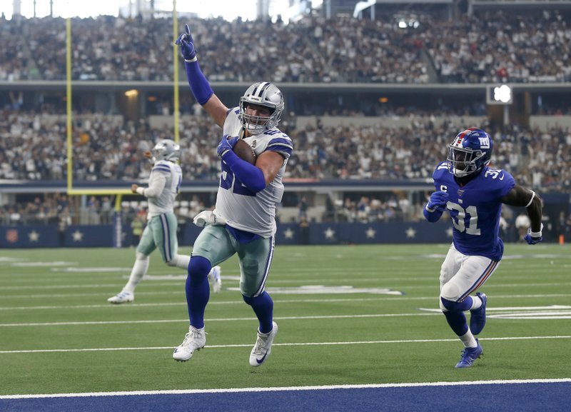 In this Sept. 8, 2019 file photo, Dallas Cowboys tight end Jason Witten (82) celebrates catching a touchdown pass as New York Giants defensive back Michael Thomas (31) defends in the first half of a NFL football game in Arlington, Texas. Witten is returning to Monday Night Football in his more accustomed role as the Dallas Cowboys’ tight end and not a television analyst for the ESPN production. Witten didn’t know if ESPN asked to have him miked for the game, but wanted no part of it. He said he has done it before and he didn’t like. His focus this week is to help the Cowboys build for their big win over the Eagles two weeks ago. (AP Photo/Ron Jenkins, File)