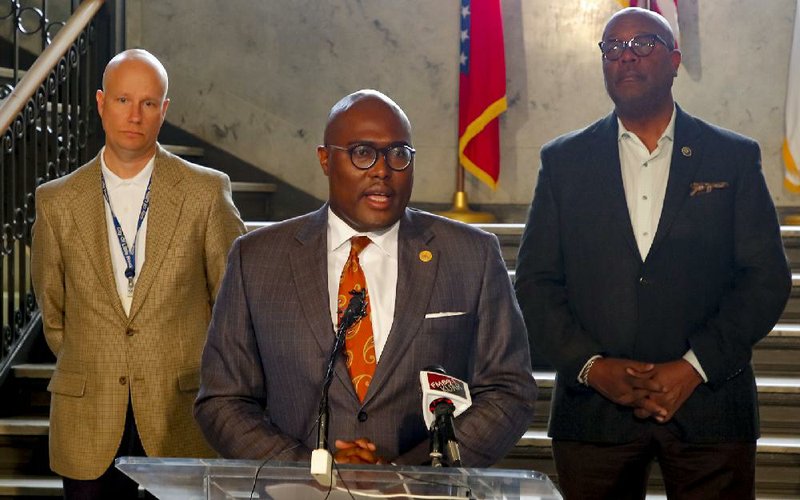 Mayor Frank Scott Jr. (center) announces several actions the city will take during the covid-19 crisis at a news conference Monday at City Hall in downtown Little Rock. Video is at arkansasonline.com/317mayor/.
(Arkansas Democrat-Gazette/John Sykes Jr.)
