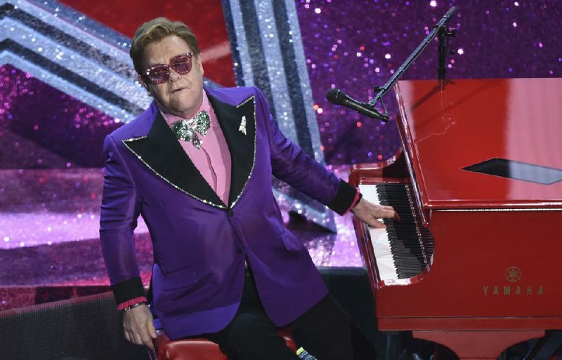  In a Sunday, Feb. 9, 2020 file photo, Elton John performs "(I'm Gonna) Love Me Again" nominated for the award for best original song from "Rocketman" at the Oscars, at the Dolby Theatre in Los Angeles. Elton John and the Foo Fighters announced cancellations Monday, March 16, for upcoming performances, joining other artists like The Who, Blake Shelton and Dan + Shay. (AP Photo/Chris Pizzello, File)