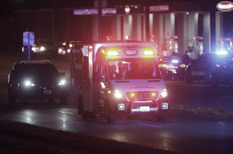 An ambulance leaves the scene of a shooting late Sunday at a gas station in Springfield, Mo. More photos are available at arkansasonline.com/317shooting/.
(AP/The Springfield News-Leader/Nathan Papes)