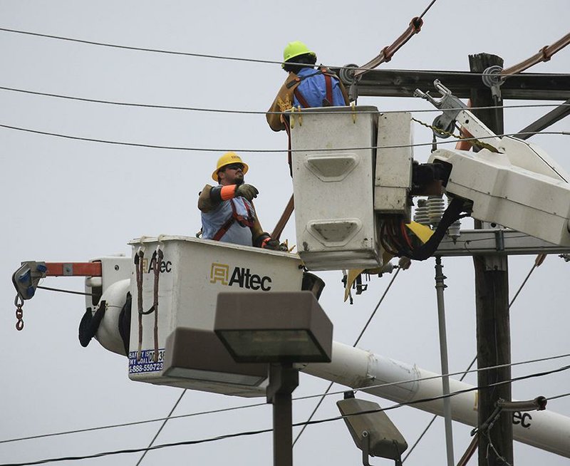 Linemen for a utility contractor work Tuesday, March 17, 2020, in Sherwood changing a utility pole on East Kiehl Avenue near Arkansas 107. Utility companies across Arkansas have pledged not to disconnect customers during the coronavirus pandemic. story.lead_photo.caption
