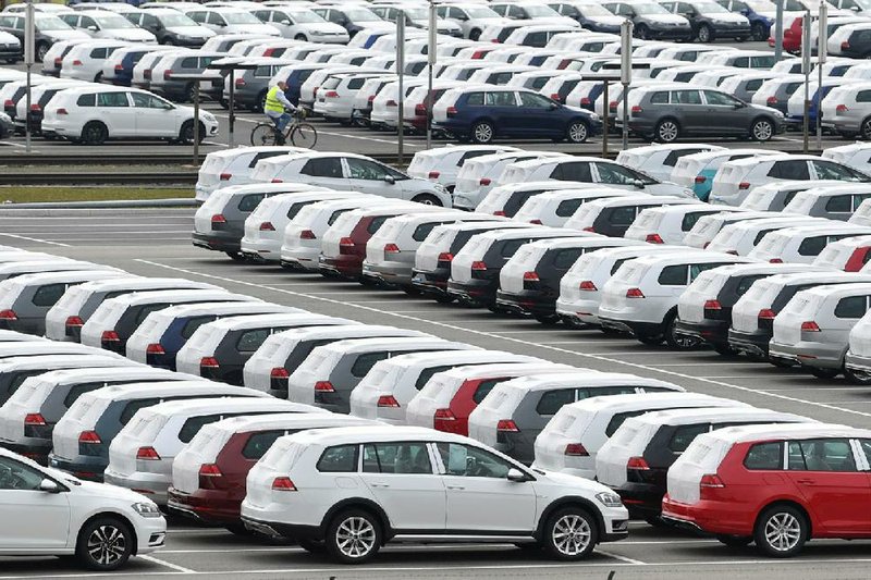 New Volkswagen vehicles sit in a lot Tuesday at the Volkswagen plant in Zwickau, Germany. German automaker Volkswagen said it is shutting down most of its European plants for two weeks because of the coronavirus outbreak. 
(AP/Hendrik Schmidt) 