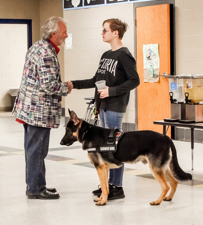 Courtesy photo Gracie Key thanks auctioneer David Barber at a fundraiser Friday night. Funds raised will help the Key family pay for the remainder of training for Gracie's service dog. The Key family also hopes to start a new nonprofit organization to help others who need a service dog.